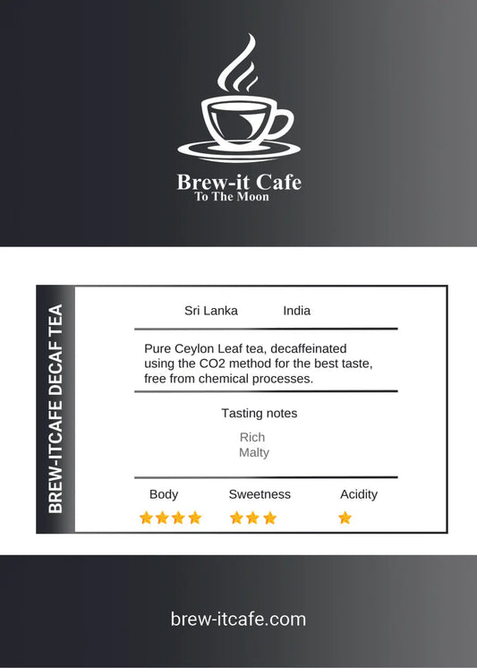Brew-itCafe Decaf Tea - Premium Ceylon blend in black packaging, placed beside a white teacup and teapot with loose leaf tea scattered on a dark table.