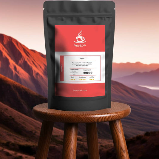 Brew-itCafe Rwanda Beans - Single-Origin Coffee with fruity cranberry notes on a stool against a scenic mountain backdrop. Premium gourmet coffee packaging.