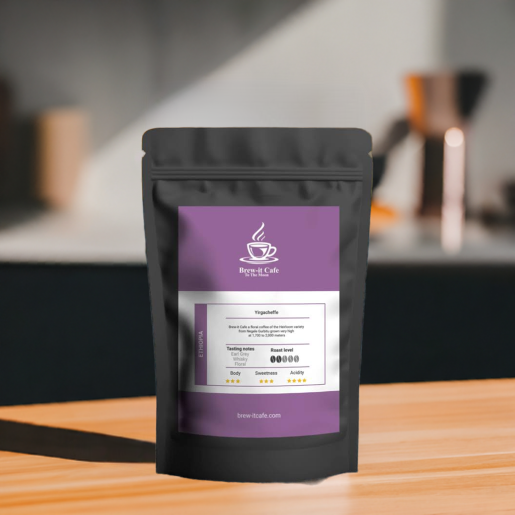 Brew-itCafe single-origin coffee in a black resealable bag with purple label on wooden table