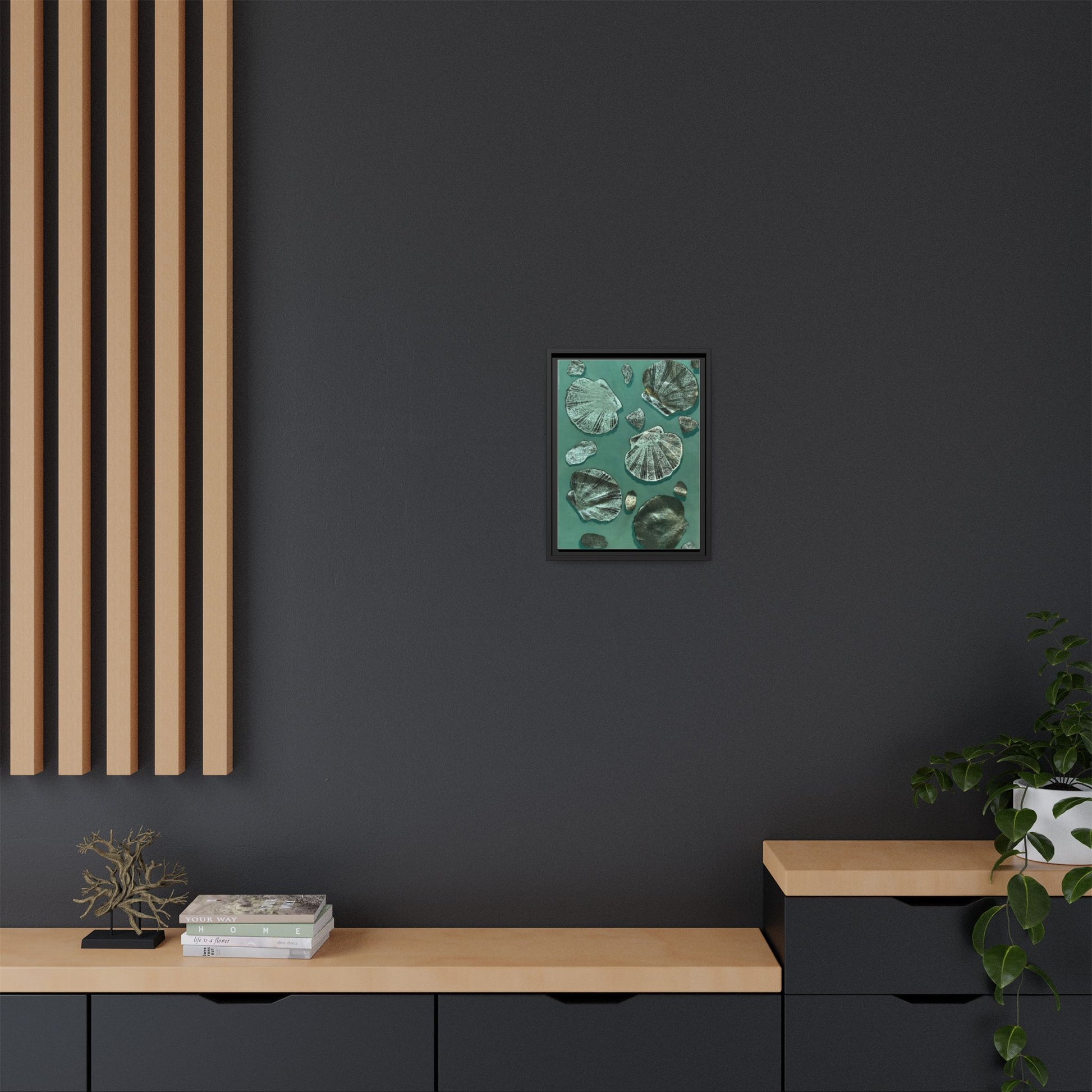 Framed multi-color seashell wall art displayed on a modern dark wall in a stylish room